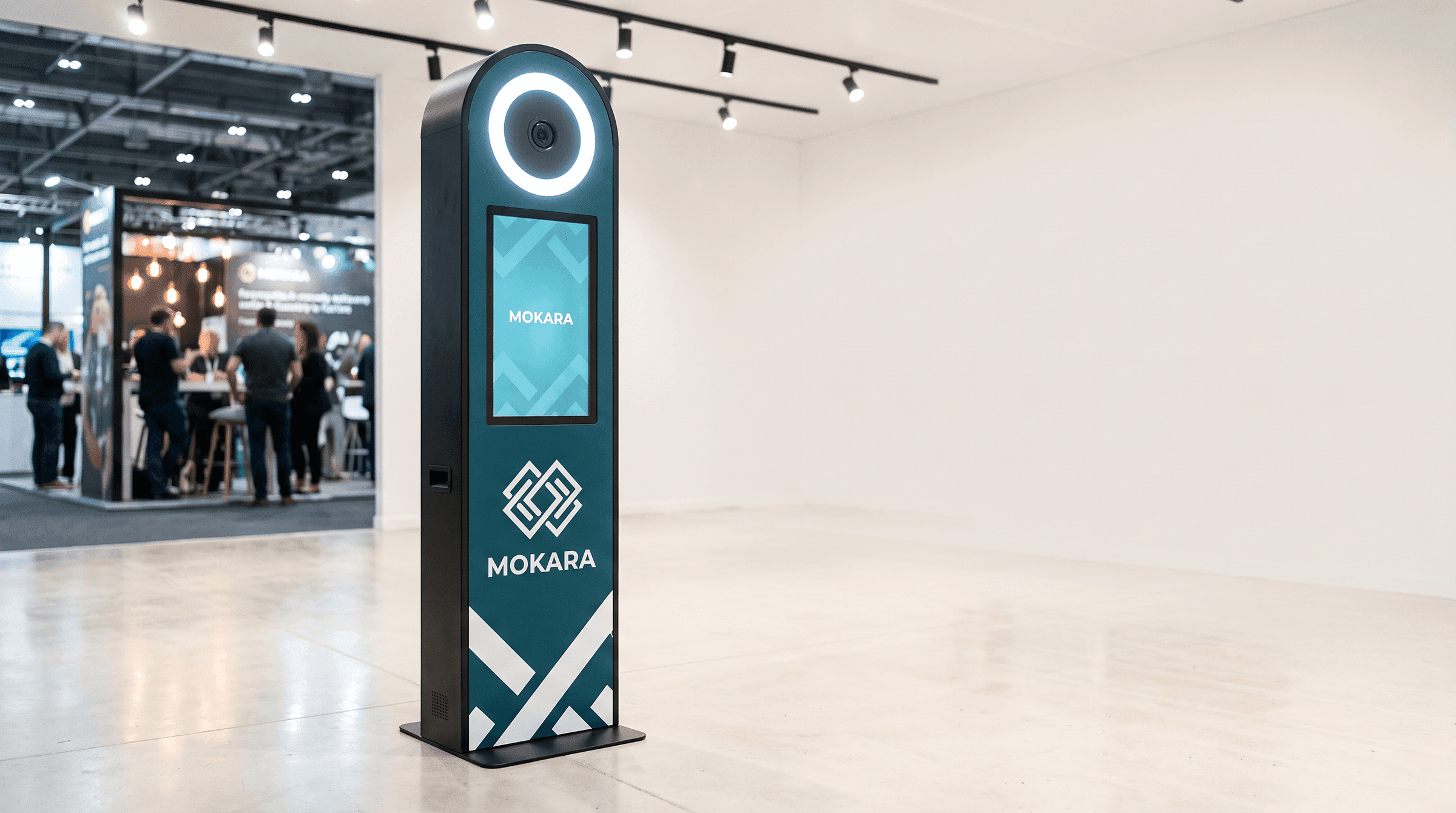 A portrait station totem wrapped in a teal technology brand at an expo.